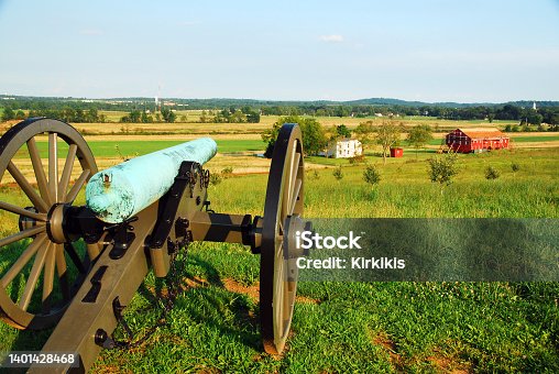 istock Civil War Cannon over a farm 1401428468
