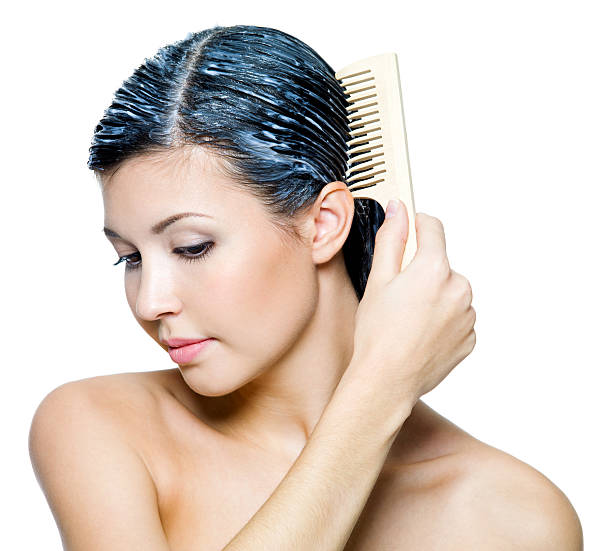 istock woman dyeing hairs and combing them 140142996