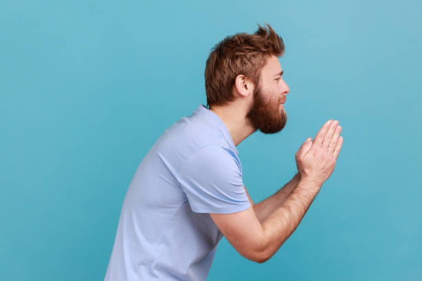 istock Man holding arms in prayer, asking help or forgiveness with imploring eyes sincere asking permission 1401432703