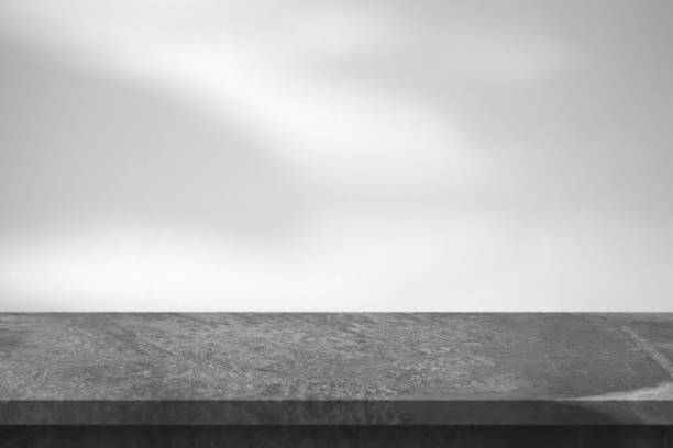 istock Marble table with tree shadow drop on white wall background for mockup product display 1401437572