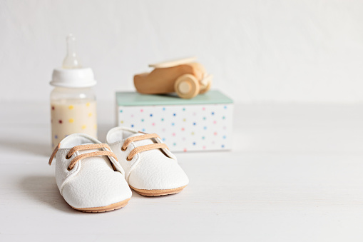 Baby shoes and qccessories. Organic newborn fashion, branding, small business idea. Baby shower invitation, greeting card