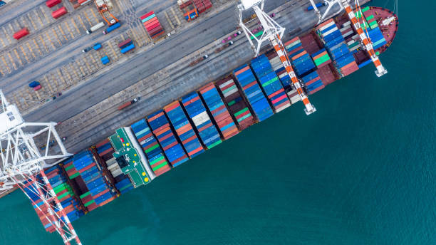istock Aerial view container ship working at seaport, Global business company import export logistic and transportation of international global trading by container cargo freight shipping cargo vessel. 1401437828
