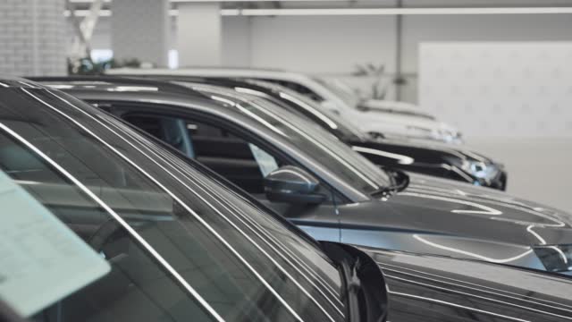 New and used cars are on display for sale and rental in the bright showroom.