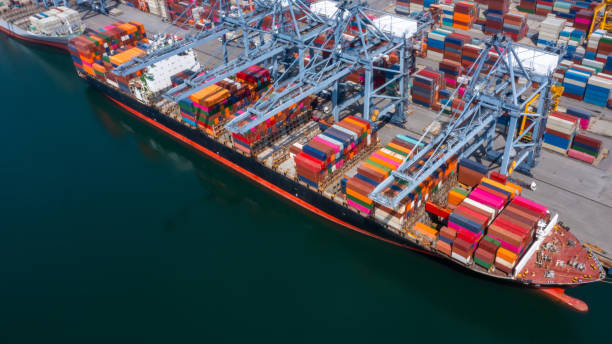 istock Container ship carrying container box in import export to commercial port, Global business cargo freight shipping commercial trade logistic and transportation oversea worldwide by container vessel. 1401440015