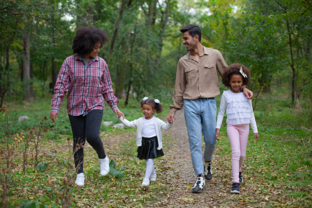 istock Happy family walking along a path in the woods 1401440117