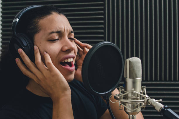 inspired man singing inside music studio, broadcasting live on social networks stock photo