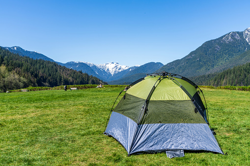 the sun shining on the white tent