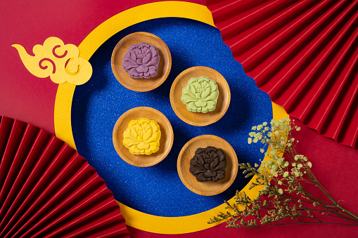 colorful flower shape snowy mooncakes with Chinese decorations