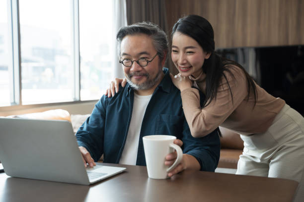 istock Middle-aged Asian Wife encourages cheerful husband to work. 1401447073