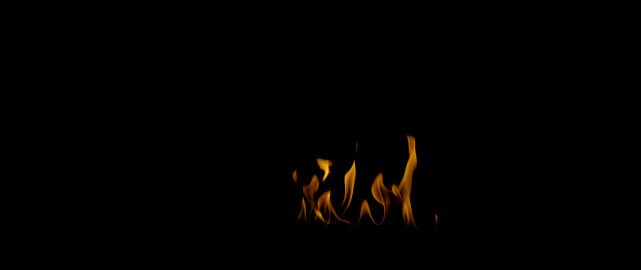 Fire flames on black background. Burning fire flame. Abstract background on the theme of fire, light and life