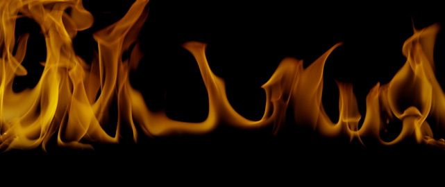 Fire flames on black background. Burning fire flame. Abstract background on the theme of fire, light and life