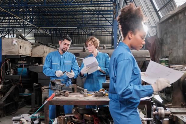 istock Professional workers teams work in the metalwork manufacturing factory. 1401451033