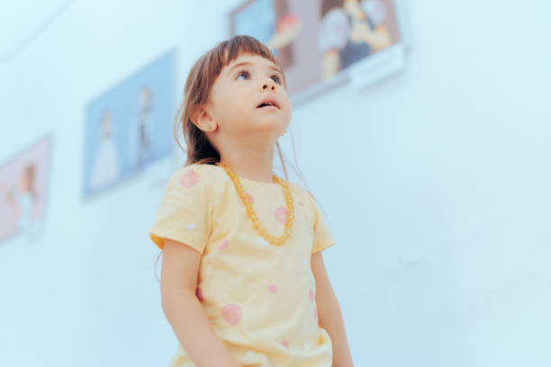 Curious Little Girl learning more about Modern Art Child visiting art gallery looking at illustrations preschooler caucasian one person part of stock pictures, royalty-free photos & images