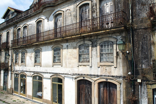 Mold-covered facade of a residential townhouse, at Largo Antonio de Magalhaes, Ponte de Lima, Portugal