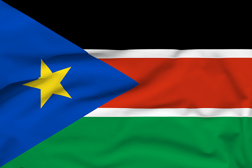 Seamless loop animation of the South Sudan flag on a blue sky background. 3D Illustration. High quality.