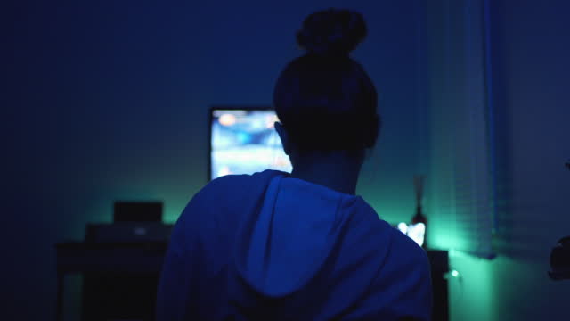 Young Asian Woman Focusing on Her Game while Trying to Win.