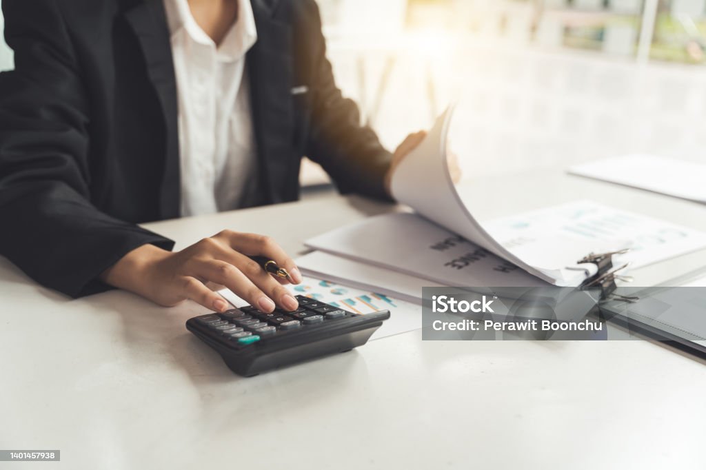 Business woman accountant or banker making calculations. Savings,Business Financing Accounting Banking and economy Concept. Internal Revenue Service Stock Photo
