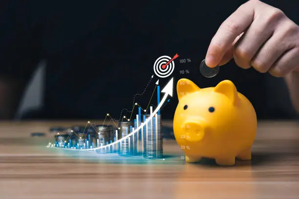 Photo of business people save money in piggy bank and goal and achievement chart graph and arrows. Concept Buying Funds Loans and Investment Profits. accumulate assets, wealth, lucrative