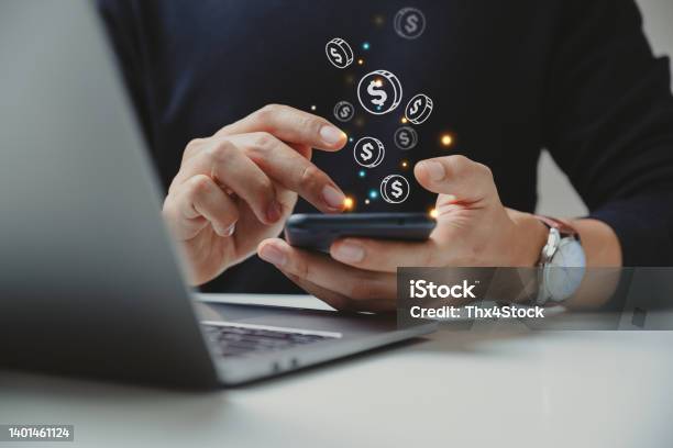 Hand Of Businessman Using Smart Phone With Coin Icon Stock Photo - Download Image Now