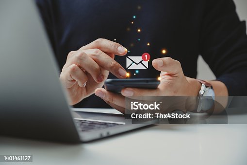 istock Hand of businessman using smartphone for email with notification alert. 1401461127