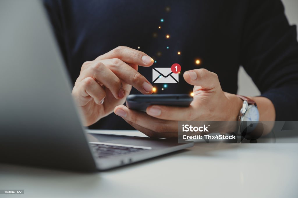 Hand of businessman using smartphone for email with notification alert. Hand of businessman using smartphone for email with notification alert, Online communication concept. E-Mail Stock Photo