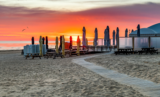 Colorful sunrise on sandy beach of the Baltic Sea