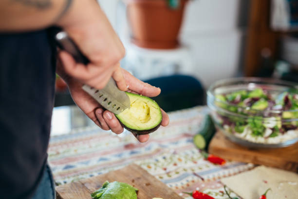 istock handsome young man preparing food in his home kitchen 1401466898