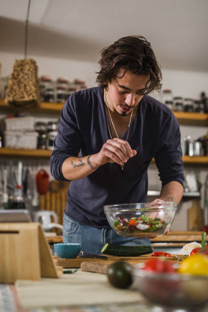 istock handsome young man preparing food in his home kitchen 1401467118