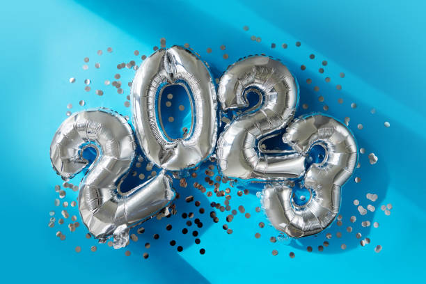 istock Silver numbers 2023 new year balloons in sunlight blue background 1401468327