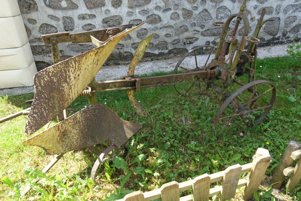 Old agricultural machine tool for plowing stored in an old farm