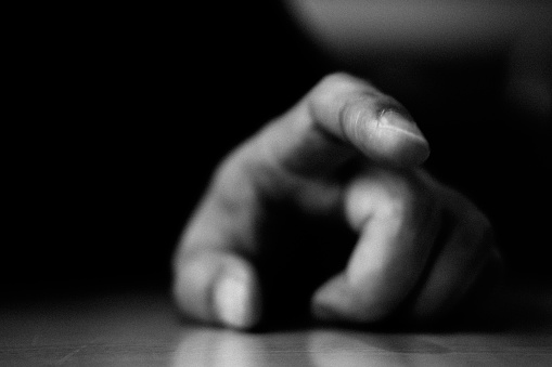 Image of a person hitting the table with a finger ,Monochrome