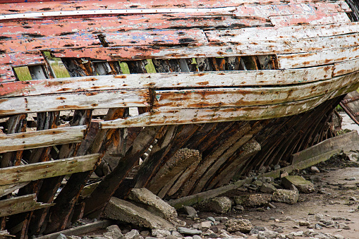 Stranded wood fishing boat rotting away on a tidal flat