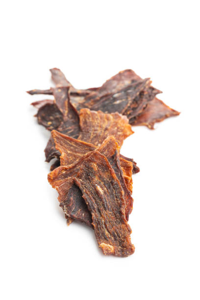 istock Beef jerky meat. Dried sliced meat isolated on white background. 1401471705