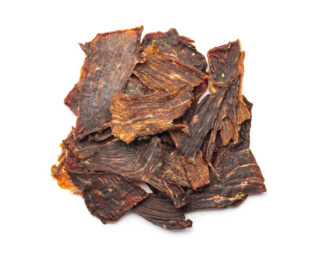 istock Beef jerky meat. Dried sliced meat isolated on white background. 1401471797