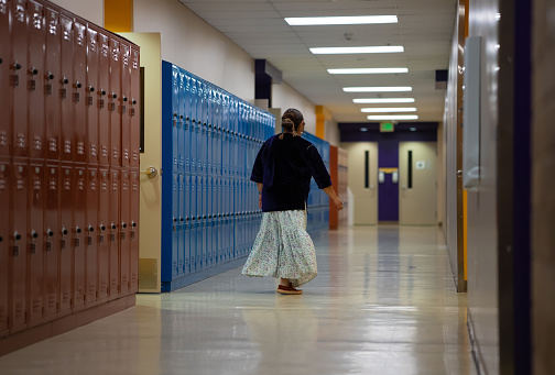 Indigenous Navajo Teacher walking and checking the school corridors