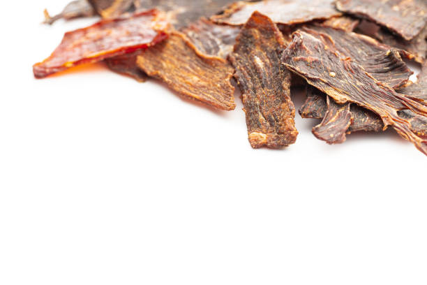 istock Beef jerky meat. Dried sliced meat isolated on white background. 1401471837
