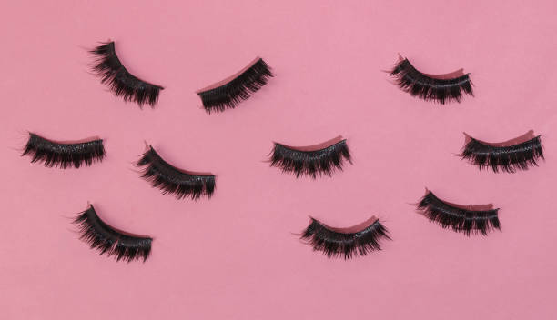 istock False eyelashes on a pink background. Minimal beauty layout 1401472847