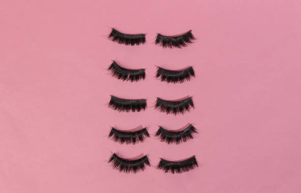 istock False eyelashes on a pink background. Minimal beauty layout 1401472850