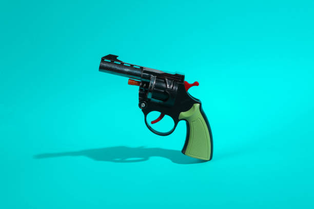 istock Toy gun on turquoise background 1401472878