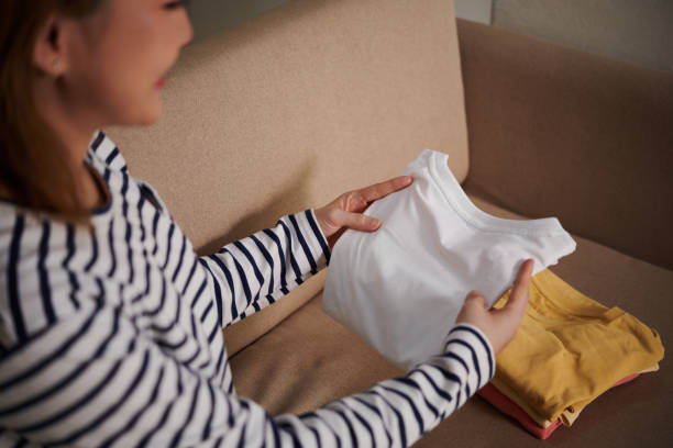 istock Woman Folding Clean T-shirts 1401472986