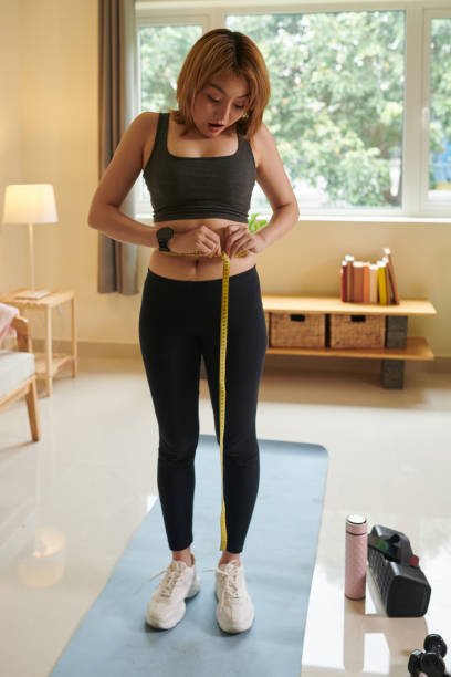 istock Woman Measuring Waist 1401473052