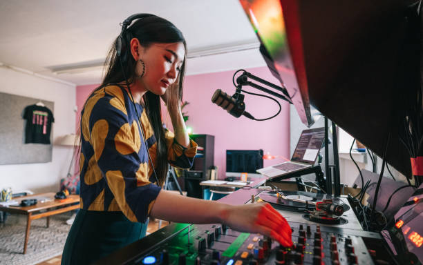 Young DJ making a online music set for her listeners stock photo