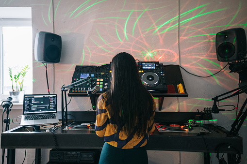 Young electronic artist mixing a new set for her listeners.