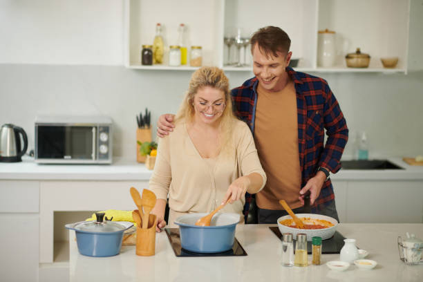 istock Happy Couple Cooking Pasta 1401474248