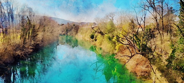 Watercolor effect of the Vipava river view in the Vipava Valley during springtime / early summer. Trees, fields, Karst plateau and blue cloudy sky in the background. Watercolor effect on a photography.