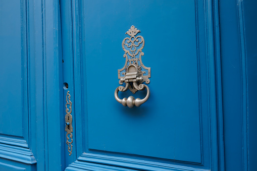 knocker on blue ancient wooden door classic antique home entrance