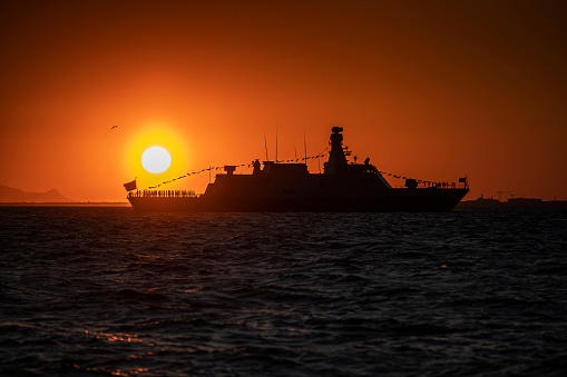 Izmir. Silhouette of a warship on the background of the sunset over the Aegean Sea