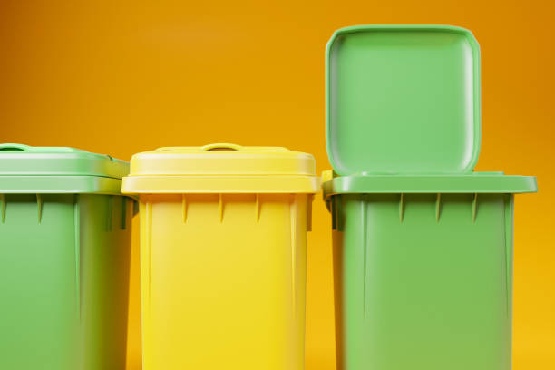 istock Green and yellow garbage bins with open lid on orange background, 3d render illustration. 1401478360