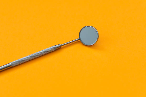 istock dental mirror on an orange background 1401478533