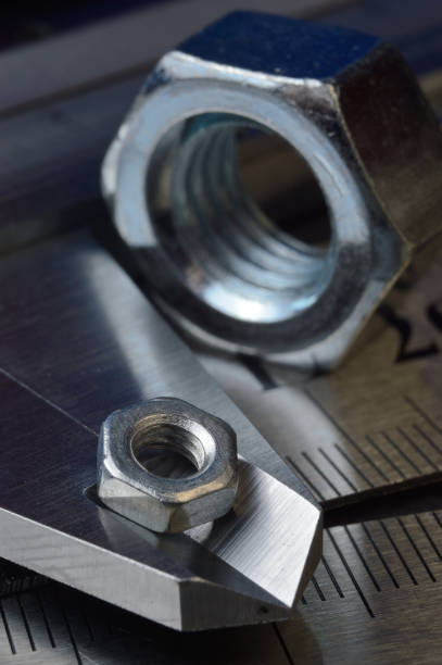 istock Accurate measuring tool caliper and metal ruler lie in place with nuts. close-up 1401478720